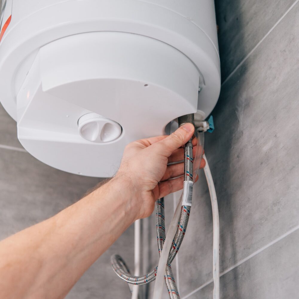 cropped-shot-of-male-plumber-repairing-electric-boiler-in-bathroom.jpg